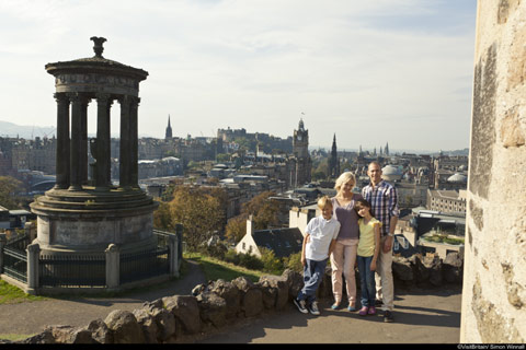 Family pose at Carlton Hillwith Edinburgh Castle and Princes Street in the background