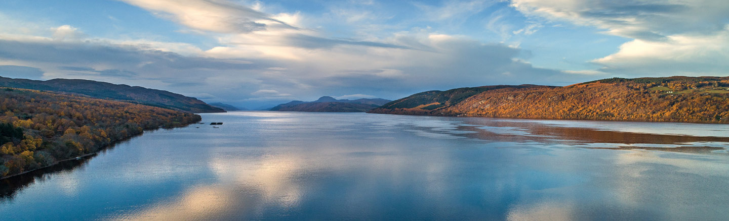Bright panoramic view of the calm waters of Loch Ness