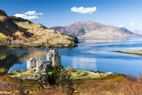 Looking down on Eilean Donan Castle sitting on a little island with the mountains on Kintail in the background