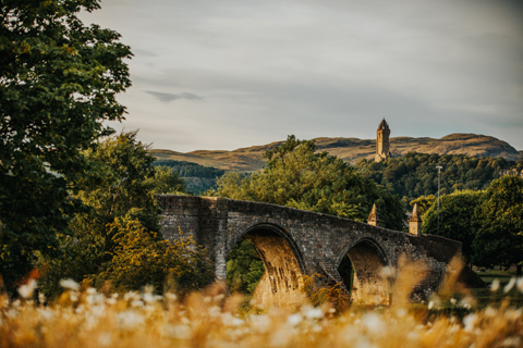 Stirling Bridge which straddles the River Forth overlooked by the Wallace Monument on Abbey Crag
