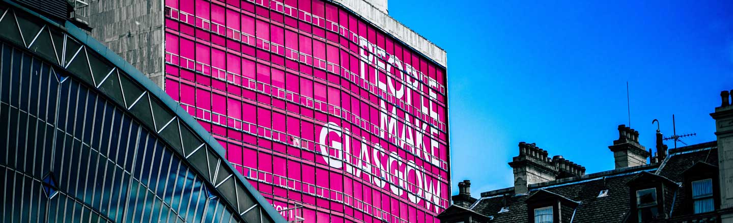 Office block in Glasgow City Centre showing the pink People Make Glasgow logo