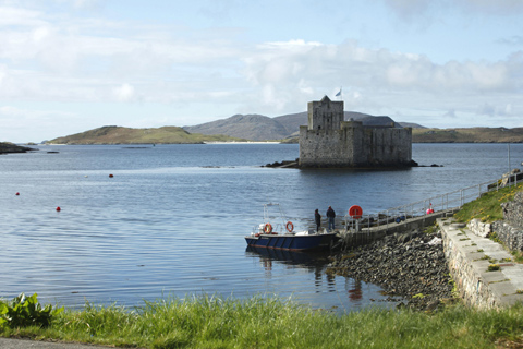 Two visitors board a boat to visit Kismul Castle which sits in the waters of Castlebay 