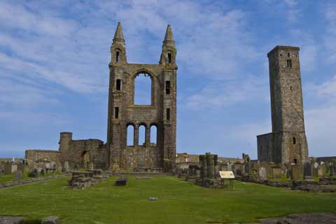 The ruins of St Andrews Castle and St Rule Tower against a bright blue sky