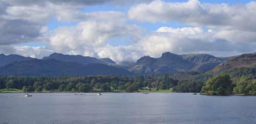 Blue water of Lake Windermere with mountains in the background 