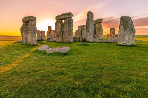 Sunrise at Stonehenge give a gentle view of the massive monolith stones
