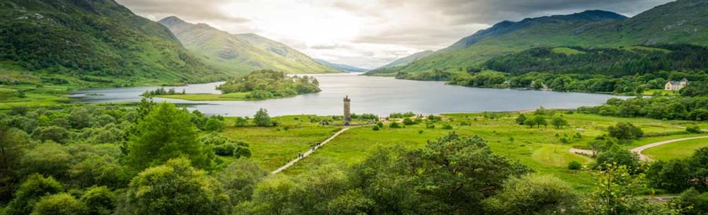 Panoramic view of the Glenfinnan Monument standing by the banks of Loch Shiel