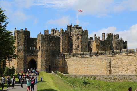 Visitors make their way to enter Alnwick Castle through the Portcullis Gate