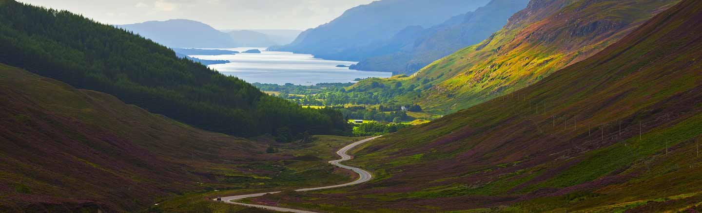 Scenic road from Kinlochewe through Glen Docherty with Loch Maree in the background