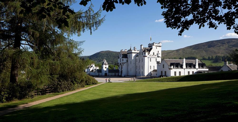 Looking through the trees towards white-washed Blair Castle with the Perthshire Hills in the background