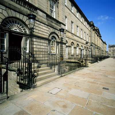 row of grand houses along a wide paved street in Edinburgh New Town