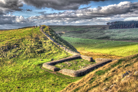 Walkers look down on the ruins of Nick Castle and Hadrian's Wall