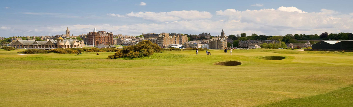 St Andrews seen from across the grass fairways and bunkers of the Old Course