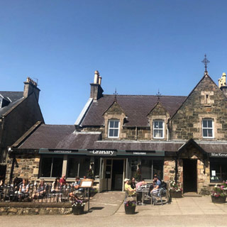 People enjoying al-fresco dining at tables outside the Granary Restaurant