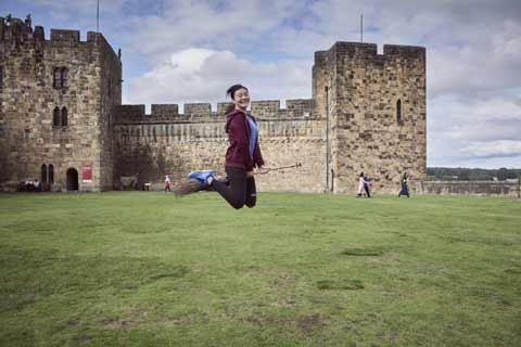 Girl flying a broomstick at Alnwick Castle