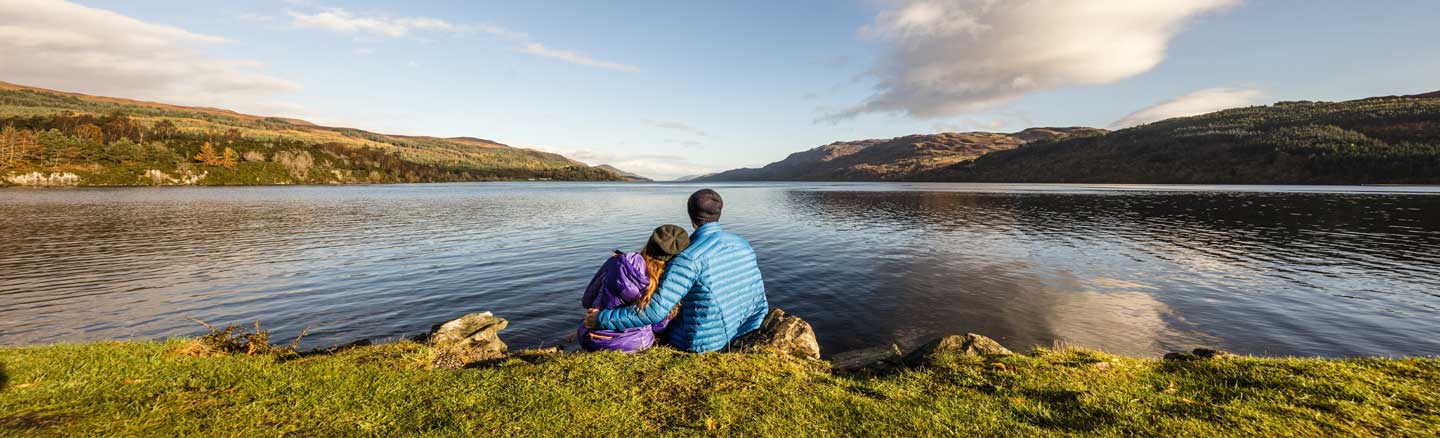 Couple sitting on the banks of Loch Ness
