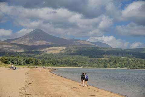 Walkers on the beach of Brodick Bay