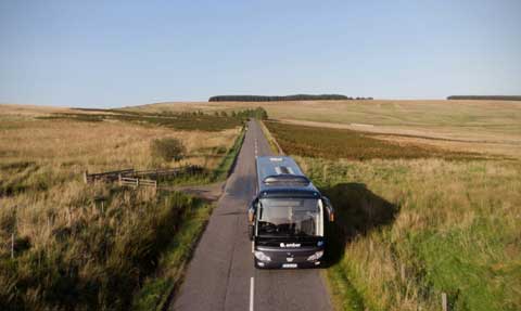 Ember coach travelling through the Highlands