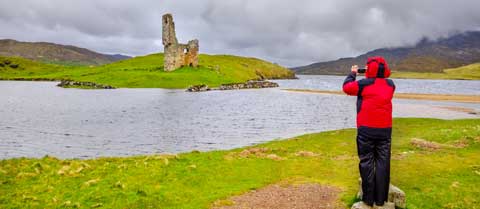 A photographer captures the view of Ardvreck Castle