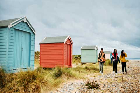 Colourful beach huts on Findhorn Beach