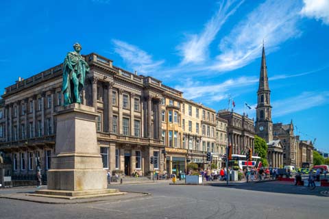 Statue in the centre of George Street with the steeple of St Andrews and St Georges Church in the background