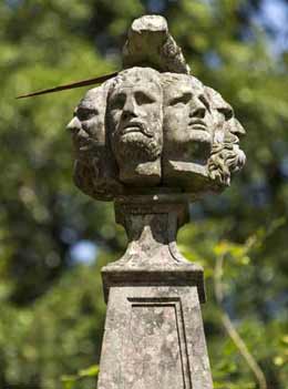 Carvings of seven heads that sits at the top of the Well of Seven Heads memorial