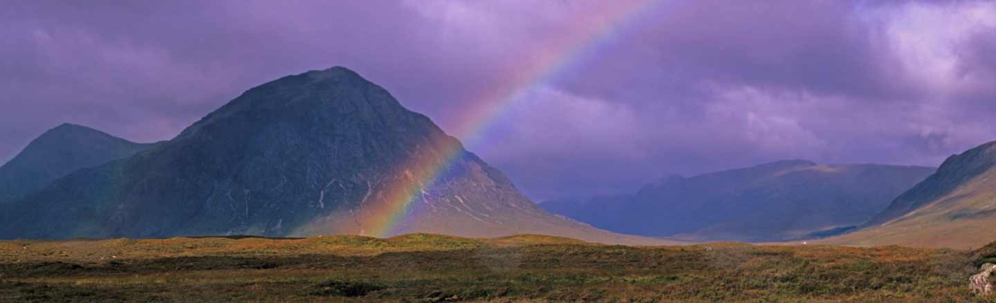 A rainbow rises above Buachaille Etive Mor