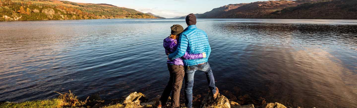 Couple standing on the banks of Loch Ness