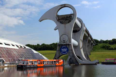 A cruise boat sits in the basin at the bottom of the Falkirk Wheel