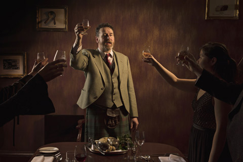 A bearded man in a kilt performs a toast to The Haggis on Burns Night 