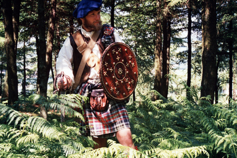 Jacobite Highlander walking through a forest