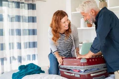 Couple packing their suitcase