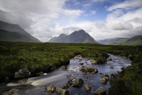 Glen Coe - river foaming past rocks with mountains in background