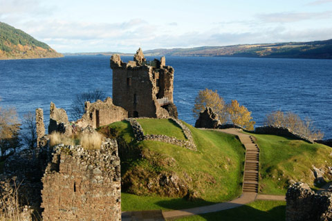 ruins of ancient Urquhart Castle on hill overlooking Loch Ness