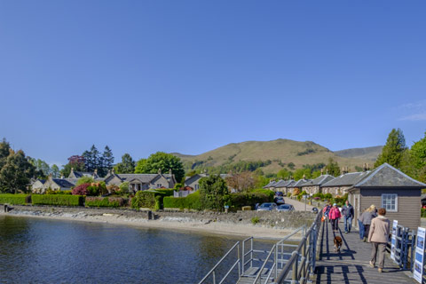 The pretty cottages of Luss and hills behind seen from the pier