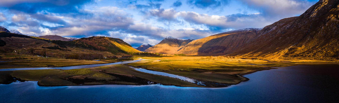 Bright blue waters of Loch Etive surrounded by the heather-clad mountains