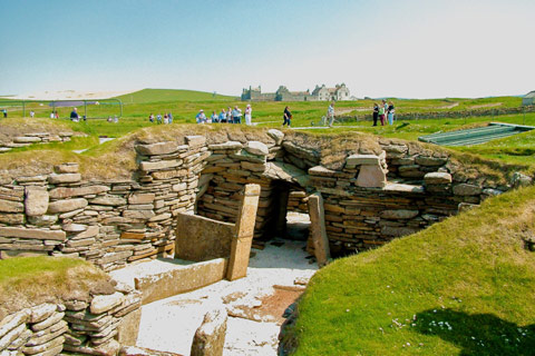 people visiting the site of Skara Brae